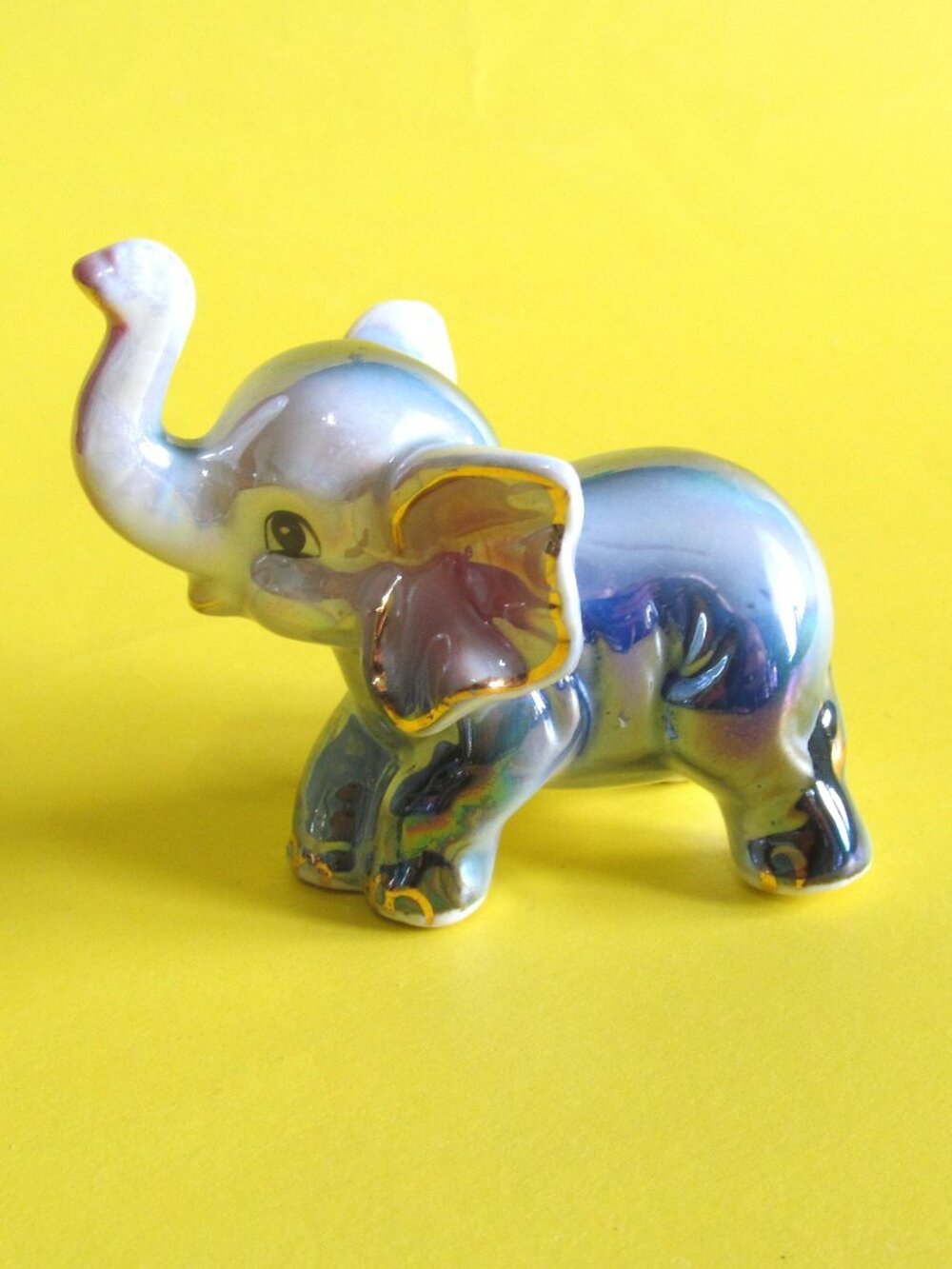 Small iridescent elephant figurine Trunk up